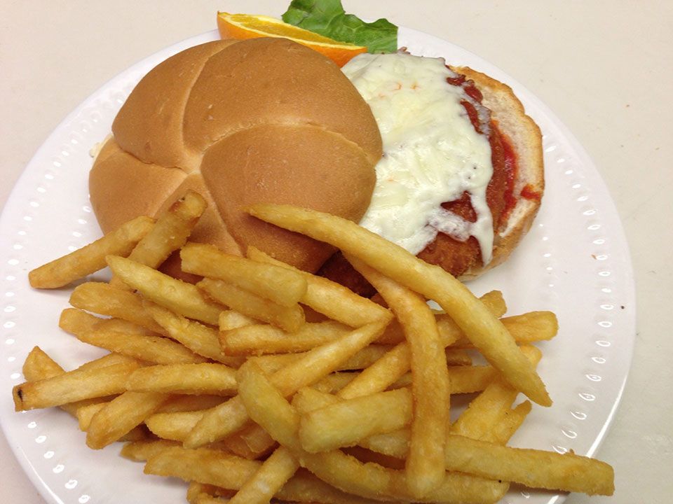 Stacked deli sandwich with fries